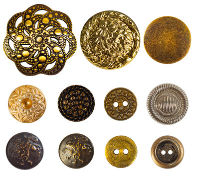 Isolated photo of various bronze and gold decorative cloth buttons or rivets on white background.