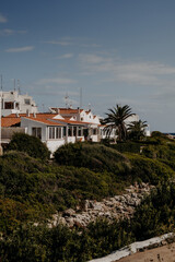 Traditional white houses and narrow streets of Binib&egrave;quer Vell, a picturesque fishing village in Menorca, Spain. Mediterranean charm.