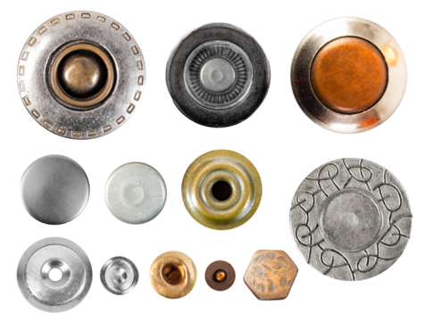 Isolated photo of various type metal cloth buttons or rivets on white background.