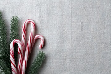 Holiday background featuring traditional candy canes and winter greenery, cozy festive styling