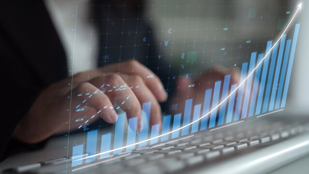 A business professional analyzes growth data and financial trends using graphs and charts on a laptop, emphasizing strategic planning for future investments. Copula