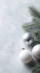 White Christmas background with assorted ornaments and pine branches, clean seasonal backdrop