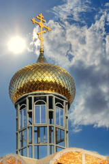 The golden dome of a church under construction against the sky