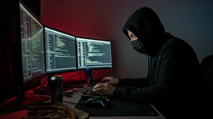 Hacker working on multiple screens in dark room with coding and snacks. Focused hacker uses technology to solve complex problems while surrounded by monitors and a can of drink. - Powered by Adobe
