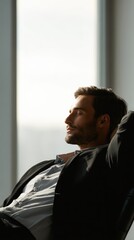 Satisfied businessman taking break after work, sunny office, relaxed pose