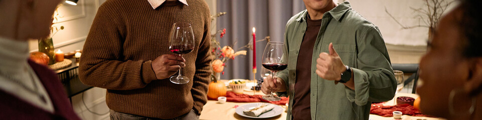 Header of group of diverse young adults and middle aged people standing together holding wine...