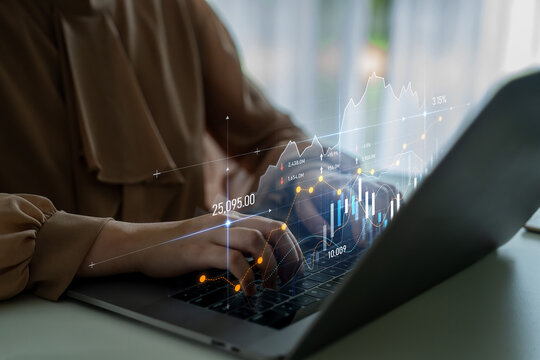 A business professional is engaged in data analysis while using a laptop, with transparent financial graphs overlaying the screen to illustrate market trends and insights. Scalp - Powered by Adobe