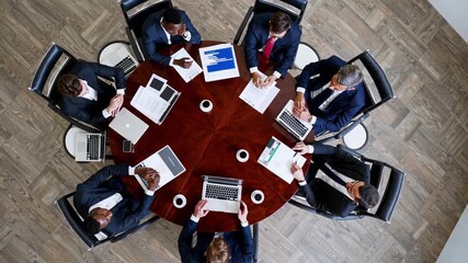corporate leaders discuss strategic plans, multinational executives gather around conference table, global board members converse and analyze business strategies in formal meeting