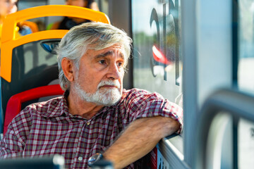 Senior man traveling by bus looking out window © unai