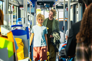Mother and son riding public transport bus