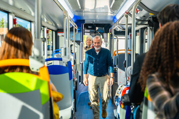 Senior man smiling travelling on public bus