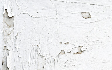 Peeling dirty old cracked stucco painted concrete wall. Leaking rain cause the wall cracked. Water damaged the wall. Uneven render surface.