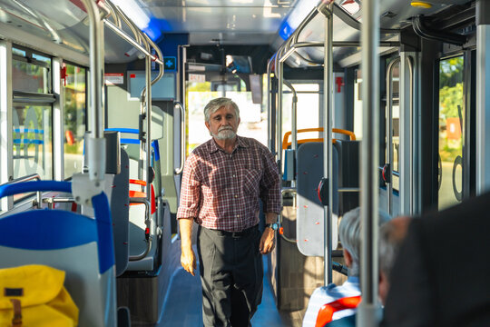 Senior man traveling by public bus transportation - Powered by Adobe