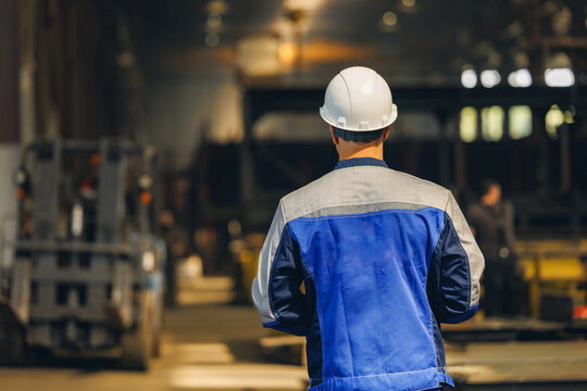 Male engineer overseeing operations in industrial shipyard cargo port facility