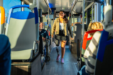 Woman with prosthetic leg walking in bus