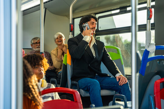 Man talking on retro camcorder in bus
