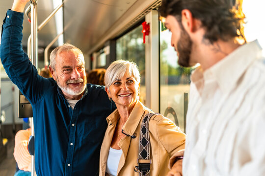 Senior couple traveling on public transport smiling