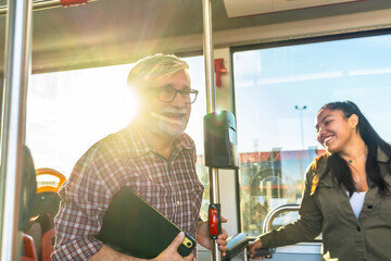 People smiling and commuting on public bus transport