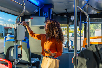 Young woman validating ticket on a bus
