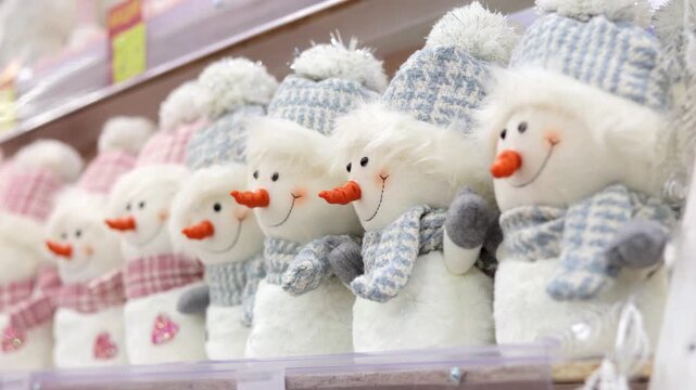 Lots of toy plus snowman on the store shelf. Christmas shopping.