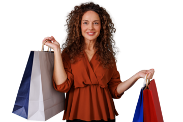 Woman with curly hair smiling and carrying colorful blank shopping bags. She is enjoying retail therapy and sales, transparent background