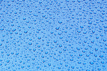 Blue water droplet pattern on glass surface, refreshing background for design projects
