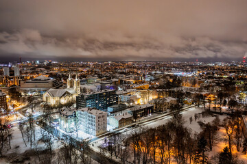 Aerial night View of Tallinn in winter, roofs are covered with snow, Christmas mood