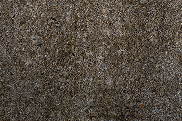 Rough asphalt texture close up with gravel and tiny stones for urban ground background