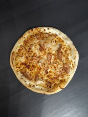 Gourmet Chicken Goat Cheese Honey Pizza on Dark Background