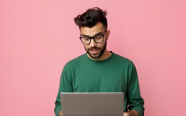 Photo of impressed funky guy wear green shirt spectacles typing modern device empty space isolated pink color background. High quality