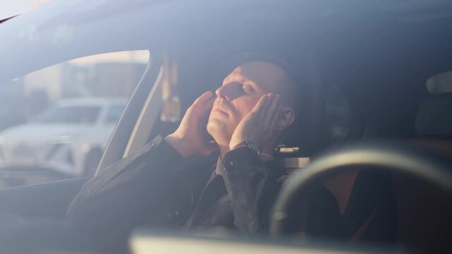 A contented man enjoys the comfort of a car seat