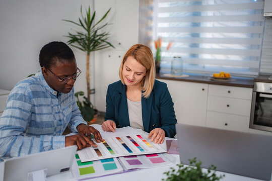 Women collaborating on a design project viewing color swatches
