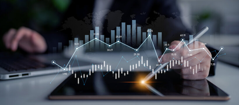 A business analyst interacts with a digital tablet displaying financial charts and graphs, showcasing data analysis and strategy in a modern office setting. Scalp