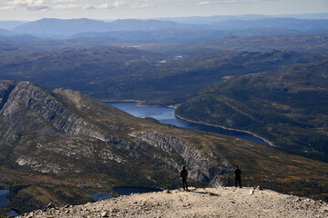  Two Young Tourists Gazing at the Breathtaking View from the Summit of Gaustatoppen, Norway's Highest and Most Beautiful Mountain