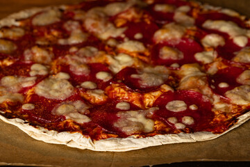 Pepperoni Pizza Baking Inside a Hot Oven on Brown Parchment Paper