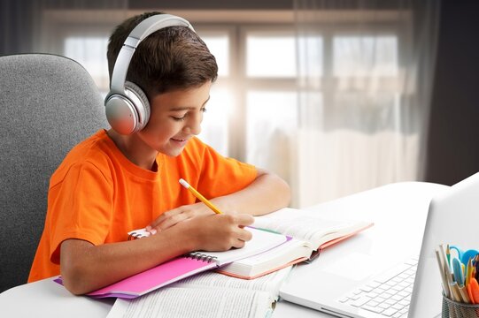 Happy schoolboy student doing homework