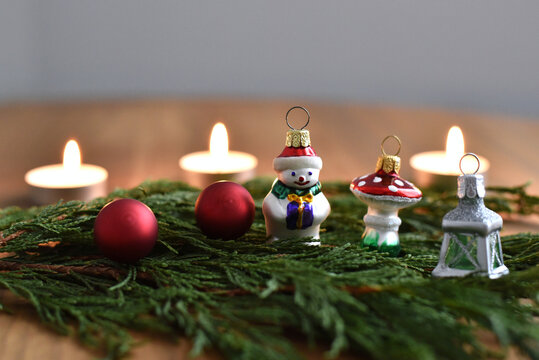 Christmas decoration with ornaments candles and green branches  - Powered by Adobe