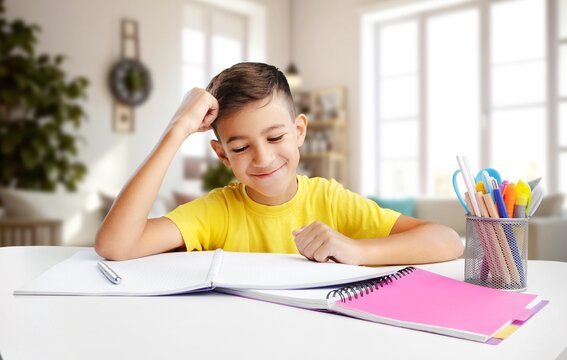 Happy schoolboy student doing homework - Powered by Adobe