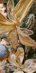Elegant white flower decoration on snowy Christmas tree branch with glitter details. Selective focus