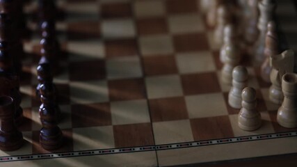 Chess, dynamic video of chess pieces on a rotating chessboard, the concept of confrontation between black and white. intellectual play, willingness to make the first move
