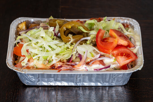 A serving of Dutch Kapsalon in takeaway tray, Popular Fast Food in the Netherlands