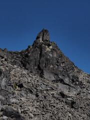 Jagged rocks in a hardened lava rock field in the Deschutes National Forest on a sunny fall day.