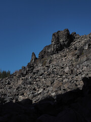 Jagged rocks in a hardened lava rock field in the Deschutes National Forest on a sunny fall day.
