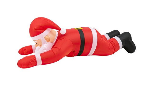 Humorous inflatable Santa Claus decoration in a classic red suit and hat, lying down in a tired or relaxing pose after the holidays, isolated on a black background