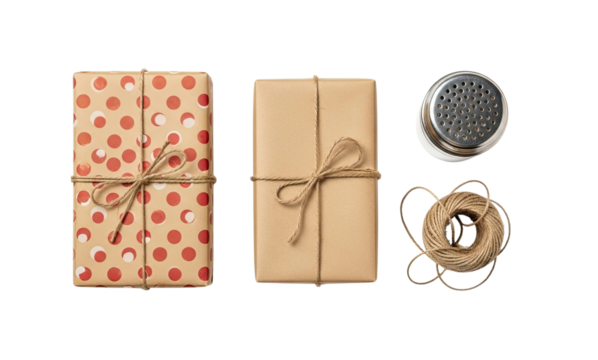 A top-down view of two rustic gift boxes wrapped in kraft paper and tied with twine, alongside a metal shaker and a ball of string, isolated on a black background