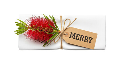 A festive holiday place setting or gift wrap decoration with a red bottlebrush flower and a Merry tag on a white napkin, tied with twine in a flat lay composition on black