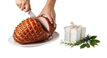 A celebratory scene of hands carving a traditional glazed holiday ham studded with cloves, served on a white platter next to a gift box and herbs, isolated on a black background