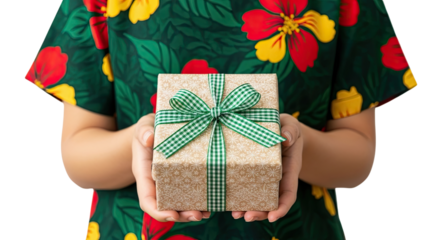 A woman in a vibrant tropical floral dress holds out a beautifully wrapped gift box with a green gingham ribbon, offering a present for a special occasion on a black background