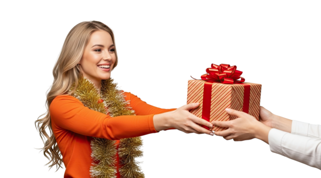 A happy young blonde woman with a festive tinsel garland smiles as she receives a beautifully wrapped holiday gift box with a red bow from another person on a black background