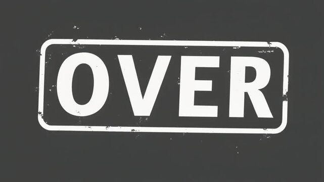A rectangular sign with the word OVER in bold white letters on a dark background.